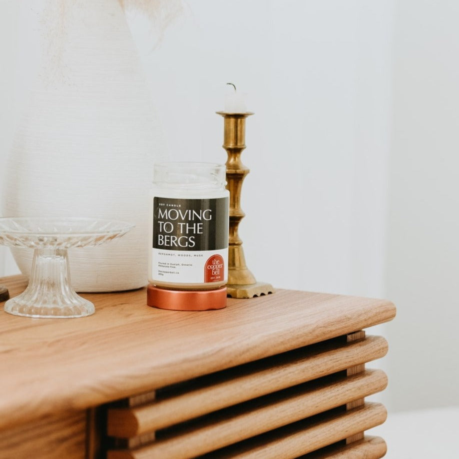 if this candle was a man, he'd make you want to move to the suburbs. moving to the bergs scented candle is masculine and sexy.