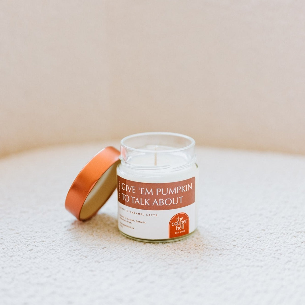 6 oz soy candle with the name give 'em pumpkin to talk about. pumpkin caramel latte scented candle