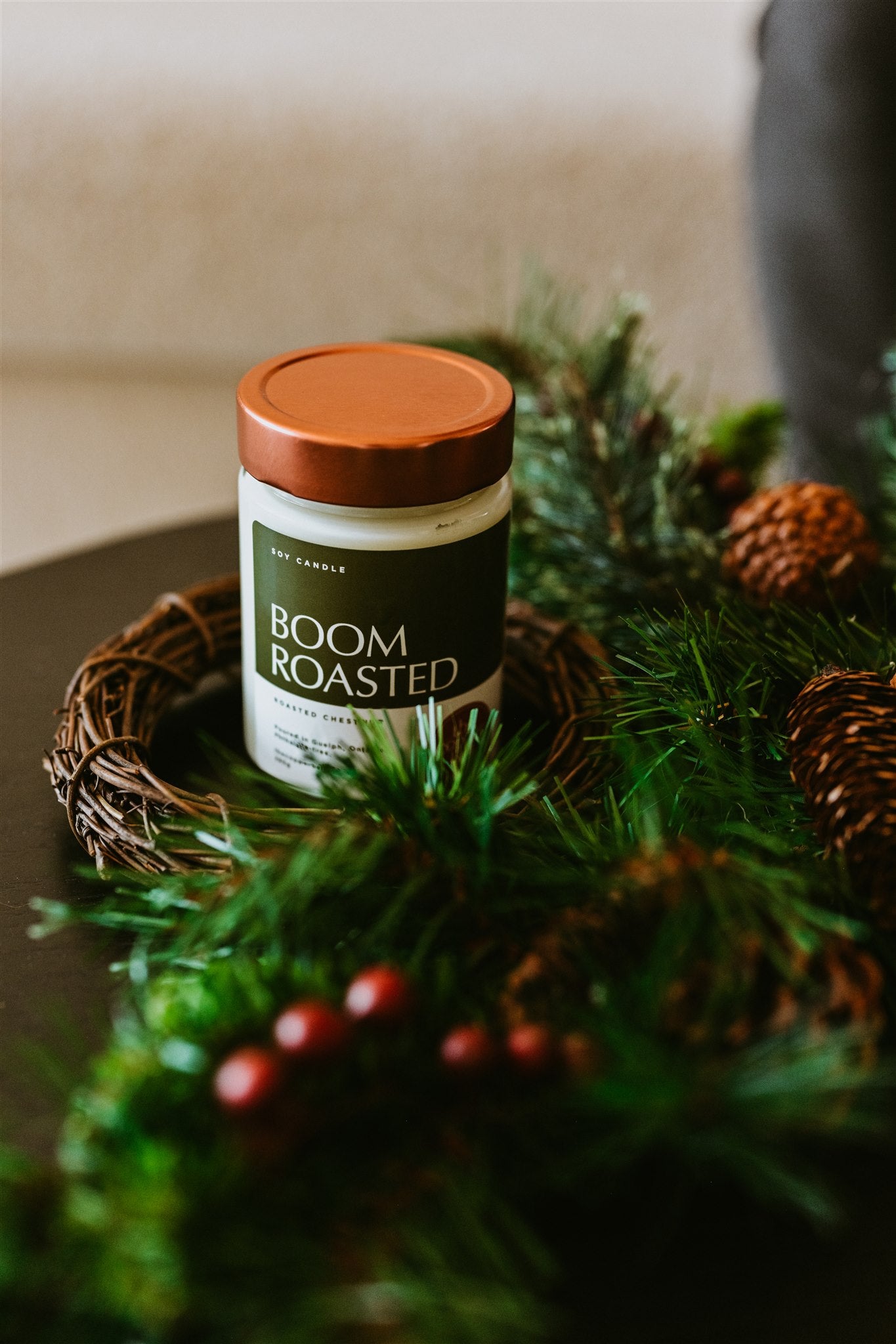 Roasted chestnut scented candle on a table with christmas decor.