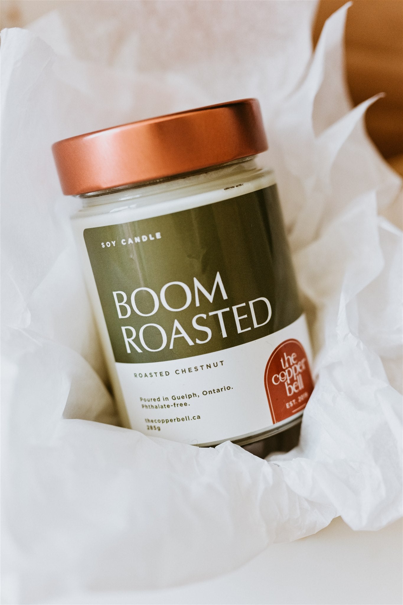 boom roasted christmas candle. Displayed in a gift box with white tissue paper.