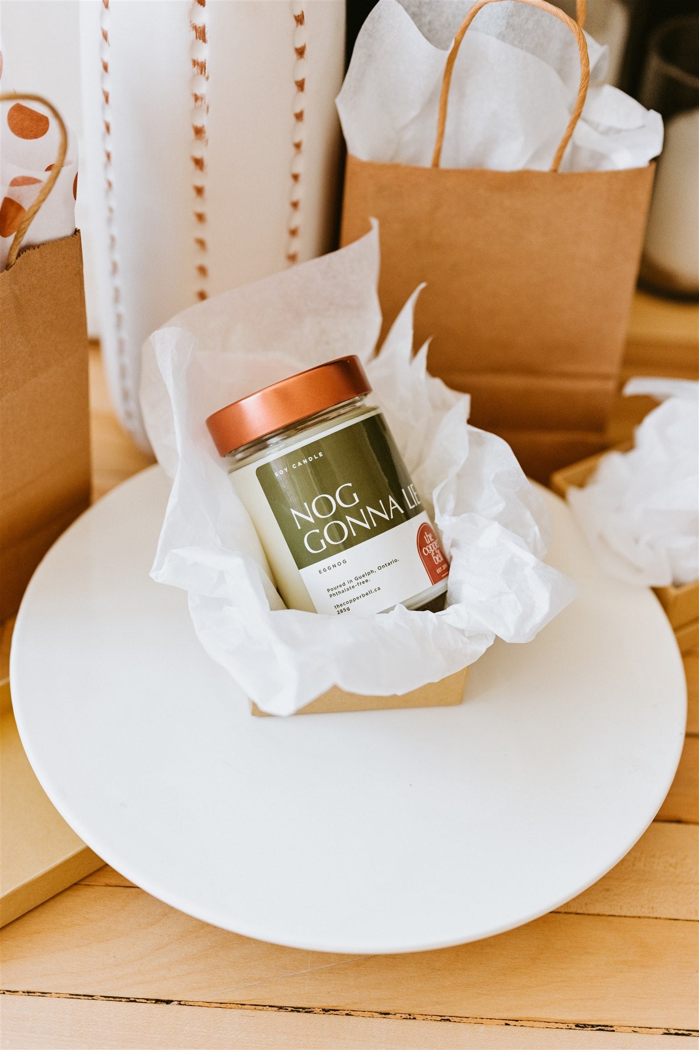 nog gonna lie funny candle. displayed in a gift box with christmas presents around.