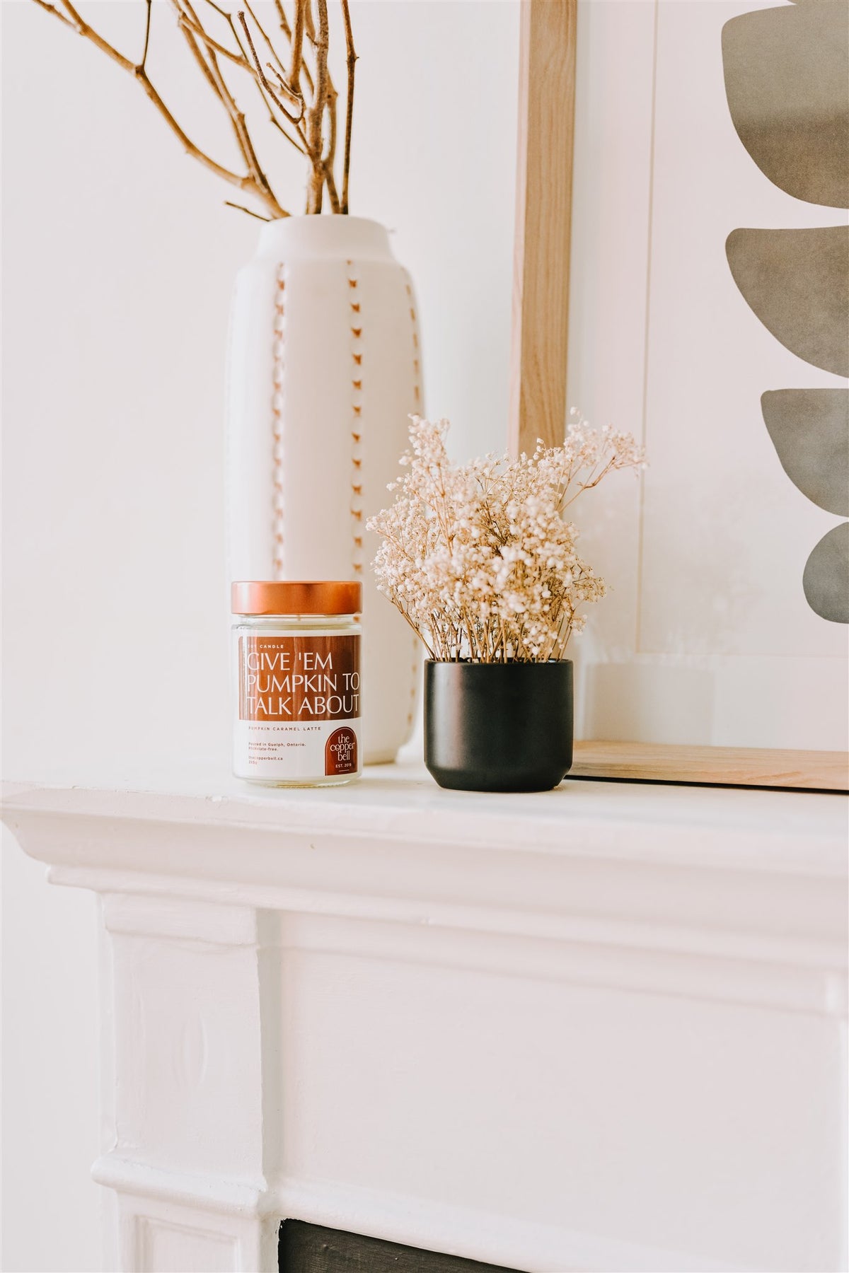 give 'em pumpkin to talk about candle home decor. displayed on a white fireplace mantel.