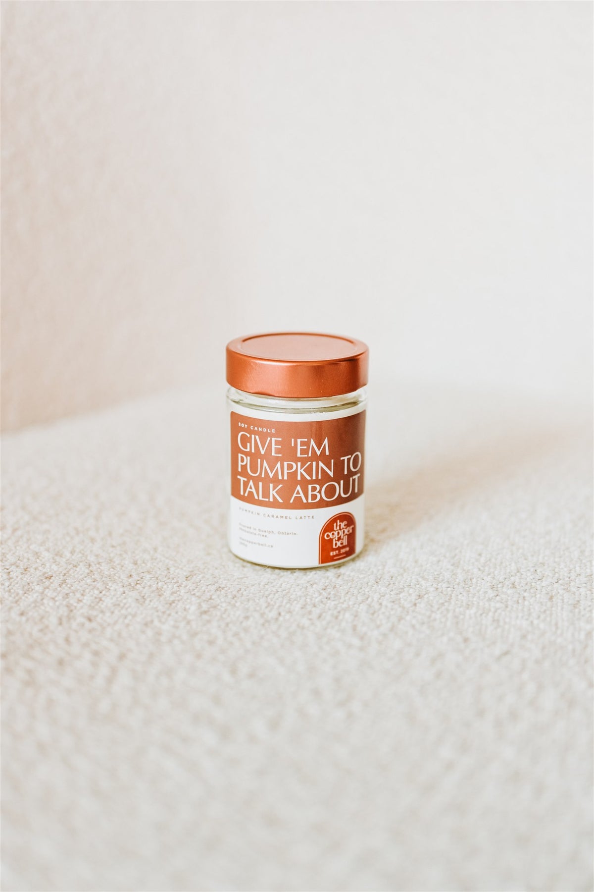 funny soy candle made by the copper bell. the candle name is give 'em pumpkin to talk about